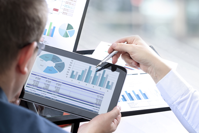 Man holds tablet, other hand holds pen and points on it